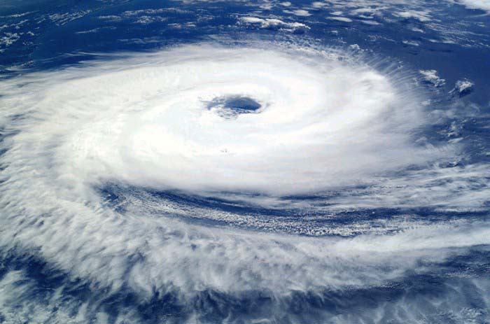 This unbelievable photo was taken from above Cyclone Catarina as it raged over the water and land below. A clear spiral can be seen with the eye of the storm also easily visible.