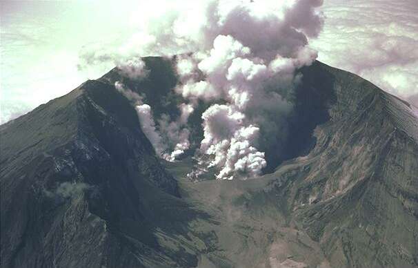 Smoke bellows from a volcano crater as an eruption takes place. This kind of volcanic activity can be quite common on active volcanoes around the world.