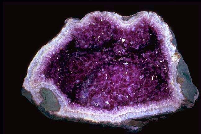 This photo shows the beautiful inside of an amethyst geode which would otherwise look like a normal rock from the outside.