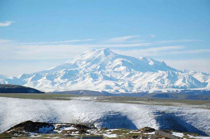 This is a beautiful photo of Mount Elbrus, the tallest mountain in Russia and all of Europe. The snow dusted mountain is an inactive volcano which has had no recorded eruptions. Mount Elbrus is 5642 metres (18510 feet) in height.