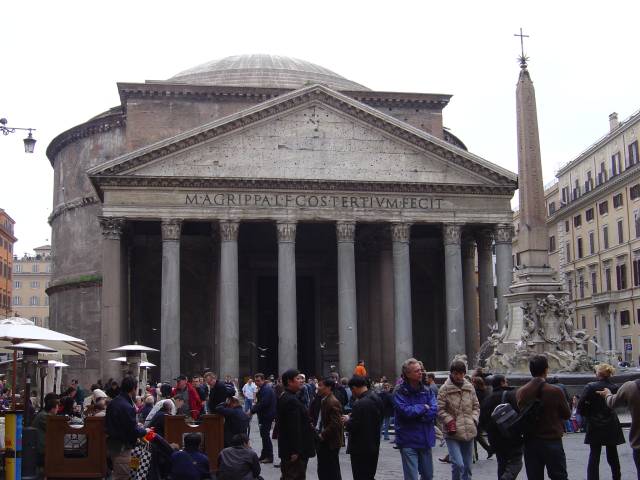 The Pantheon in Rome, Italy was built over 2000 years ago as a temple for the gods of Ancient Rome. This photo shows a number of tourists and visitors enjoying the sites around the temple which can be seen in the image background.