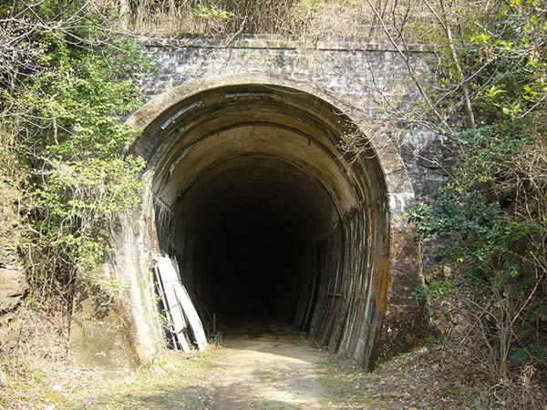 This photo shows the entrance of an old train tunnel. Named the Sodani tunnel, it was part of the Kintetsu Osaka line in Japan.