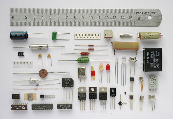 This image shows a range of electronic components. The components are shown next to a ruler to indicate their various sizes.
