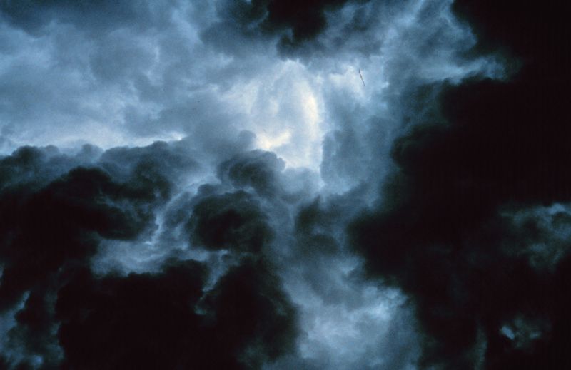 This image shows dark, turbulent clouds swirling dramatically during a heavy storm.