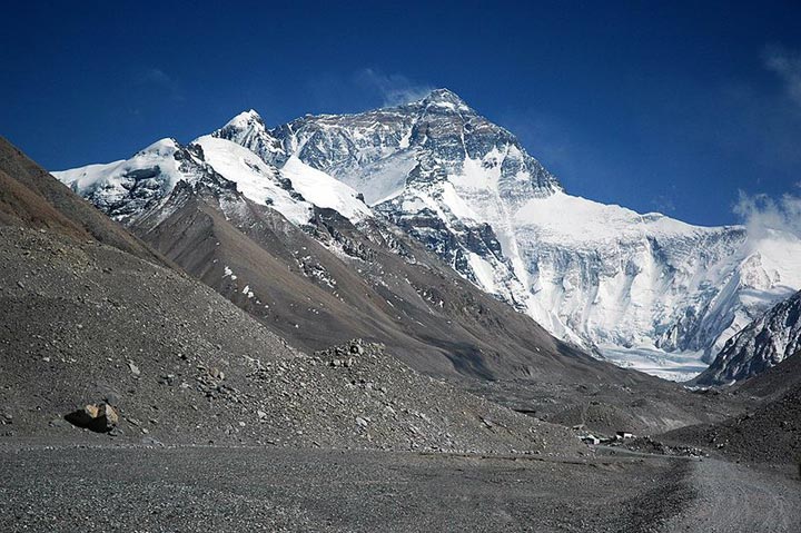 This photo shows the impressive peak of Mt Everest, the tallest mountain in the world. The image is taken from Rongbuk valley, close to base camp and the Rongbuk glacier. Found on the border of Nepal and Tibet, Mt Everest reaches an amazing height of 8848 metres (29029 feet).