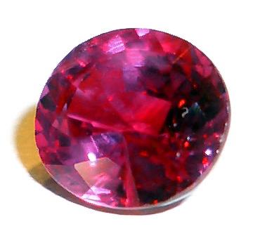 An attractive photo of an expertly cut ruby. This is an expensive kind of rock that is not commonly found. Set against a white background this ruby stands out, shining brightly as it reflects the light in a number of directions.
