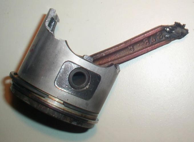 This picture shows a broken piston and connecting rod from a scooter.
