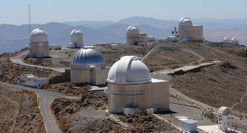 A photo taken on a fine day showing a number of telescope domes at an observatory.