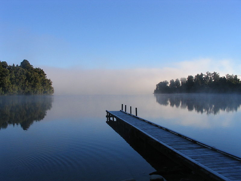 This photo manages to capture the beauty of the morning mist that lurks around Lake Mapourika in New Zealand. A peer stretches deep into the calm waters that fill the lake and hazy trees can be seen across the other side.